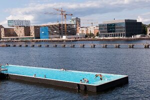 People enjoying at bathing ship pool on Spree river at Wrangelkiez, Berlin, Germany