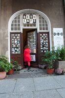 Woman coming out of Beth's cafe in Mitte, Berlin, Germany