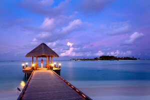 View of gazebo on jetty at sunset in Dhigufinolhu island, Maldives