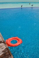 Red rubber ring at pool in Dhigufinolhu island resort, Maldives