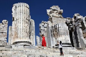 Two women photographing at temple of Apollo in Didyma, Turkey