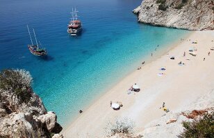 People and two ships at Kaputas beach in Turkey