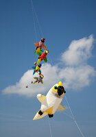 Multi-coloured flags in sky on kite festival at Fano beach, Denmark