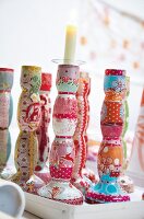 Colourful patterned candle holder with lit candle
