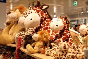 Colourful stuffed animals in form of giraffes and lions