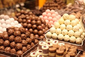 Round chocolate candies in glass shelves
