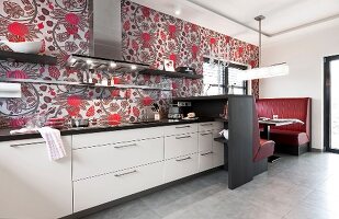 Stylish kitchen with patterned wallpaper and dining area with leather benches