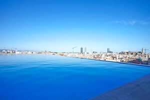 View of cityscape with Infinity Pool and Grand Hotel Central in Barcelona, Spain