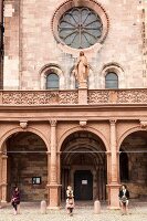 Three woman at the entrance of Freiburg Minster Cathedral, Freiburg, Germany