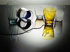 Various glasses and spilt water on table