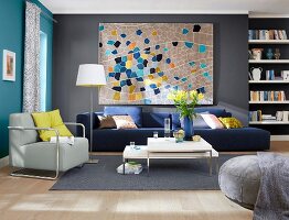 View of living room in grey, yellow and blue with picture on wall