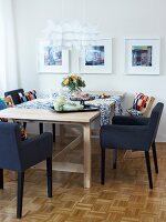 Dining room with dining table, chair, chandelier and picture frames on wall