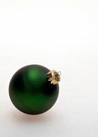 Green Christmas ball on white background, copy space