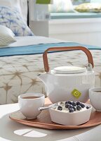 Yoghurt, coffee and tea pot in tray