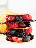 A tower of fresh berries and caramel sheets