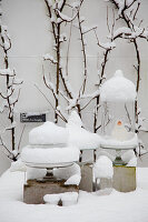 Snow-covered glass decorations in winter