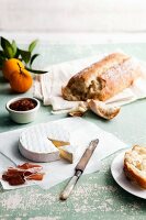 Brie with Bread, Spicy Jam, Pancetta and Oranges