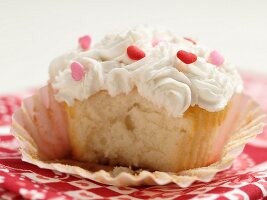 White Cupcake with Vanilla Frosting and Candy Hearts; Bitten