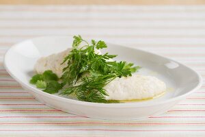 Poached fish dumpling with fresh herbs
