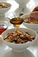 Cereals being drizzled with honey