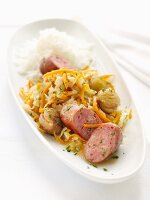 Sausage with white cabbage, carrots and a side of rice