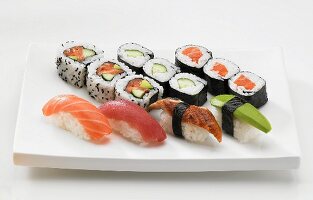 A sushi platter with maki, nigiri and inside out rolls