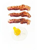 Three Strips of Bacon with a Fried Egg with a Runny Yolk