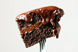 Piece of Chocolate Cake with Chocolate Frosting on a Fork
