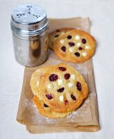 Macadamia nut and cranberry cookies and a sugar shaker