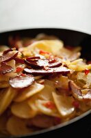 Fried potatoes with bacon and chillis