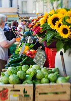 Vegetables, fruit and flowers on a market stall
