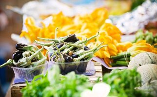 Vegetables, herbs and fruit on a market stand