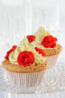 Two cupcakes decorated with marzipan roses