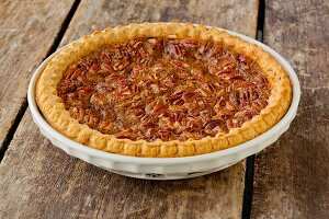 Whole Pecan Pie on a Rustic Wooden Table