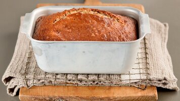 Freshly baked banana bread in a loaf tin