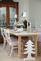 A table laid for Christmas next to a glass-fronted cabinet