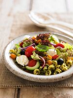 Pasta salad with pesto, tomatoes, olives and mozzarell