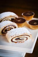 Date Filled Jelly Roll with Chocolate Toffee Candies on a White Platter