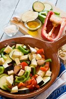 Mediterranean vegetables, raw and chopped in a ceramic bowl