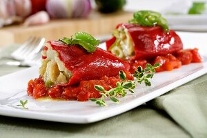Peppers stuffed with cod on stewed tomatoes