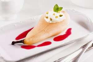 Pear poached in amaretto with cranberry sauce