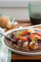 Tradional french dish Beef bourguignon with carrots and onions in a rich red wine sauce