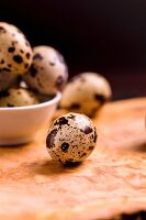 Quail's eggs in a bowl and to one side