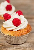 Cupcakes decorated with buttercream and raspberries