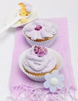 Cupcake decorated with purple buttercream and sugared violets