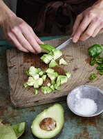 Avocado and chilli peppers being chopped to make gazpacho