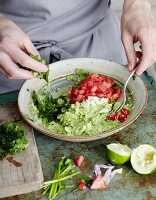 Guacamole being made: ingredients being mixed together