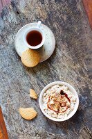 Homemade vegan cottage cheese made from soya milk with biscuits, flower powder and tea