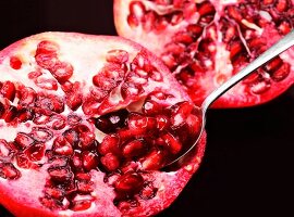 A pomegranate with a spoon