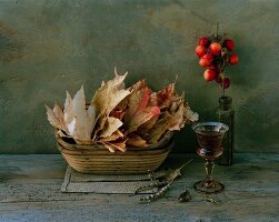Autumnal, still-life arrangement of leaves & crab apples